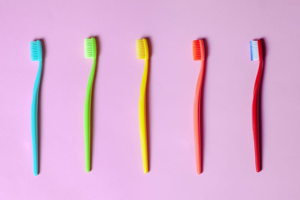 Top View On Many Tooth Brushes Of Different Vibrant Colors