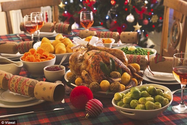 a close up of a table with a turkey, vegetables and wine