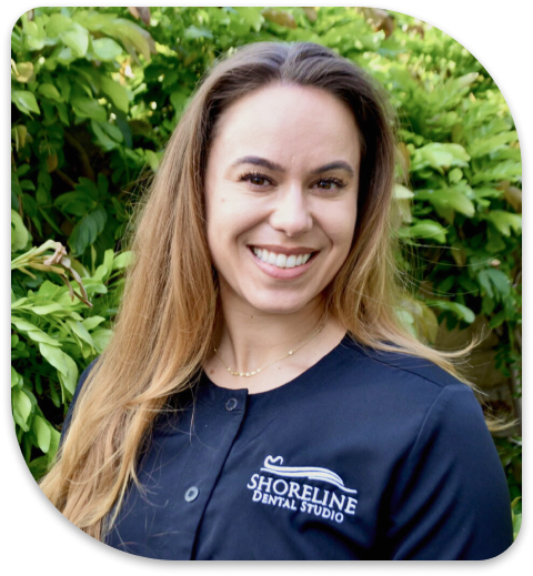 smiling woman in black shirt with blue and white logo on it