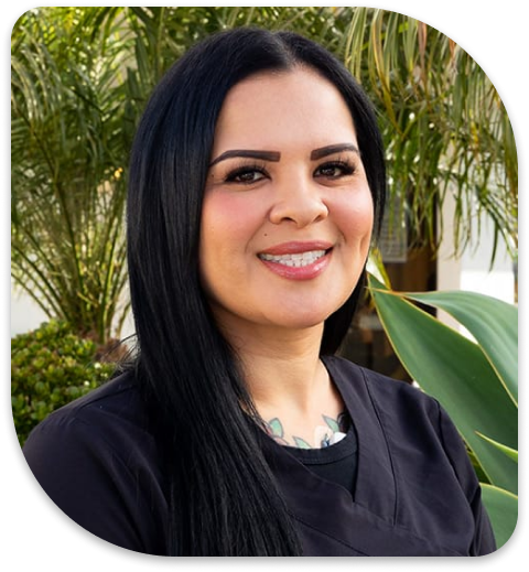 smiling woman with long black hair and a black top