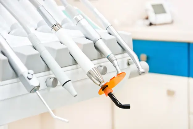 there are many toothbrushes hanging on a wall in a room